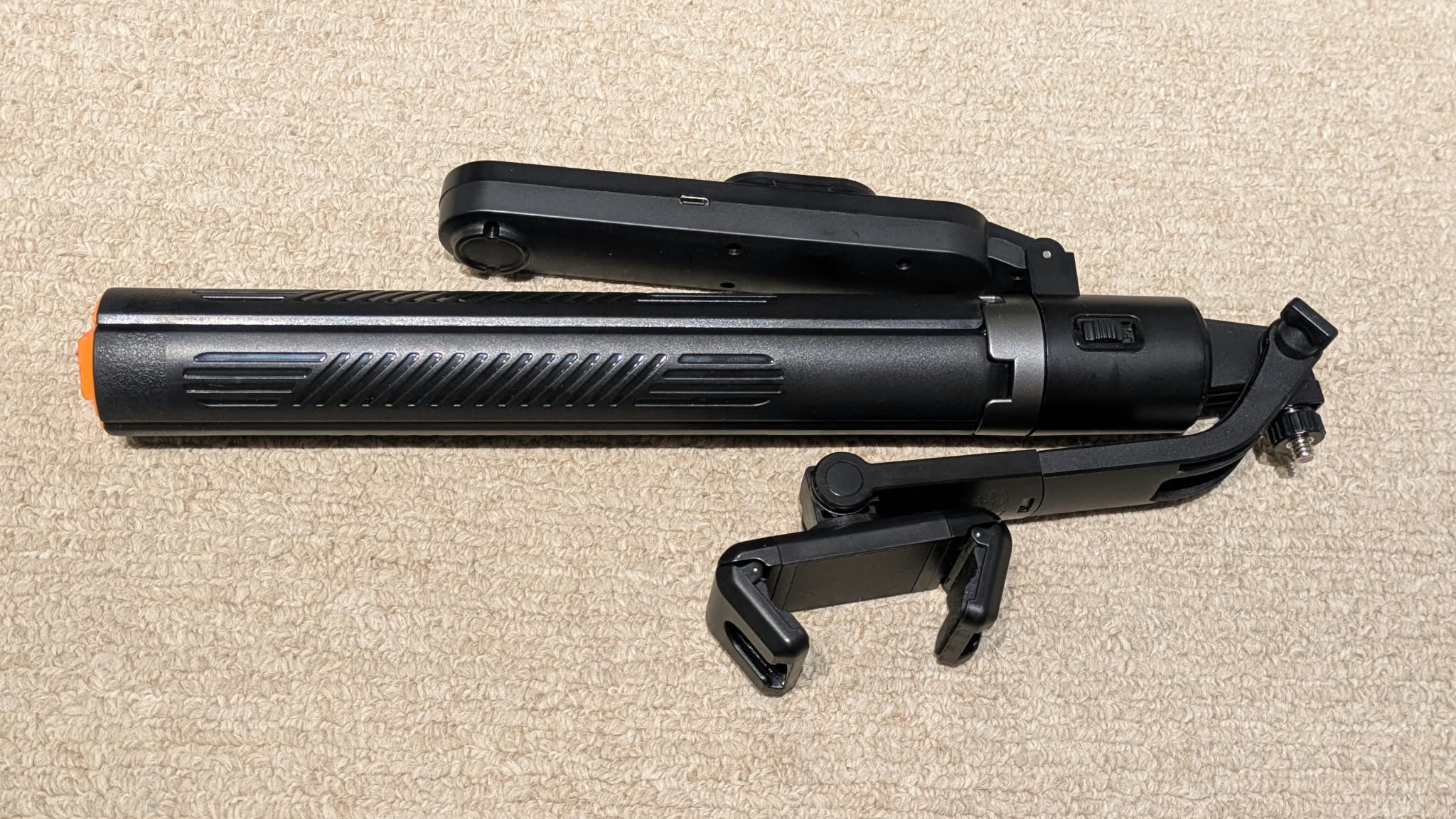 Folded selfie stick with tripod, top view
